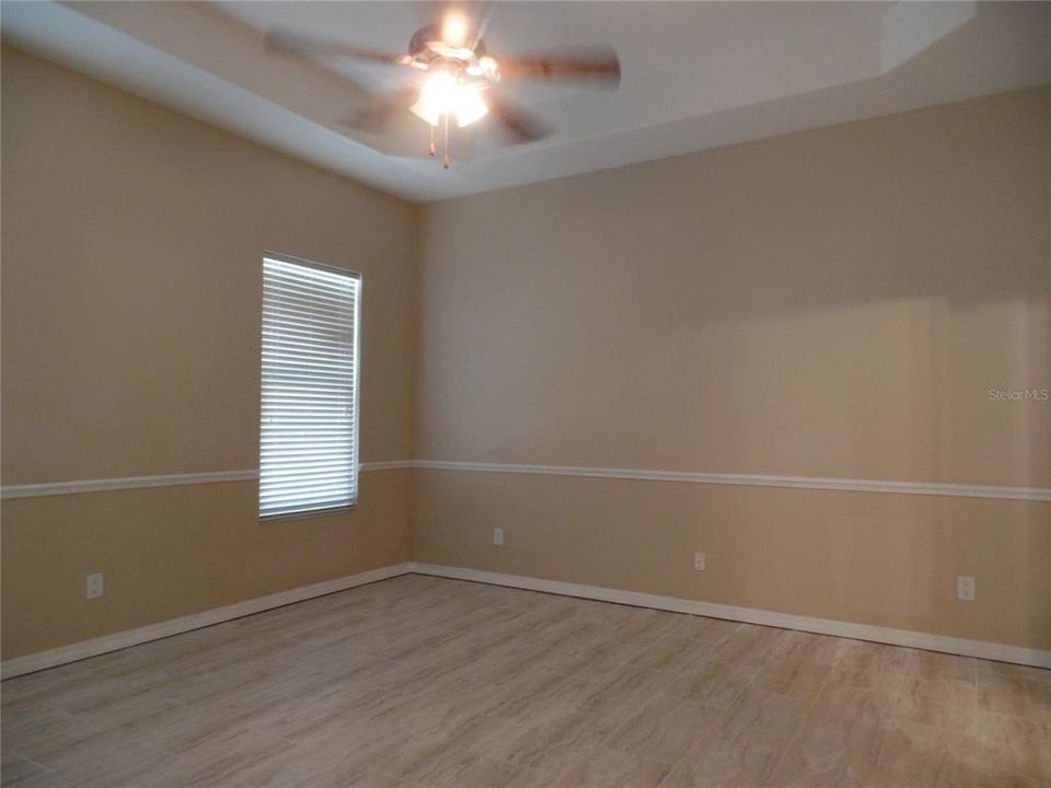 16's14' Master Bedroom.  Note tray ceiling and chair railing. Brand new vinyl tile.