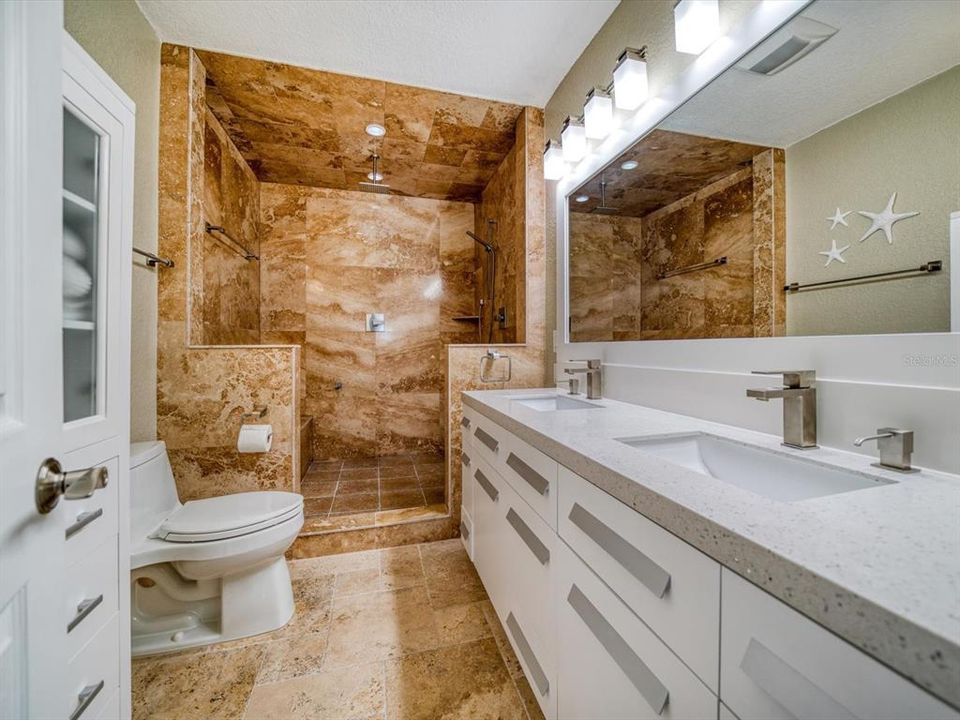 Outstanding master bath with large walk in shower, and trendy dual vanity with sparkling quartz and contemporary fixtures.