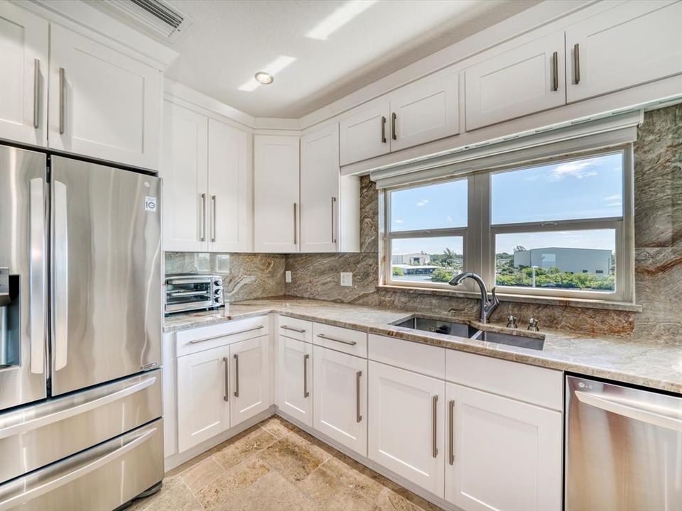Stainless appliances complement the exquisite kitchen.