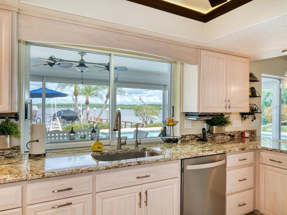 Kitchen with abundant storage, detailed tray ceiling and pass thru to lanai. Perfect for dining al fresco.