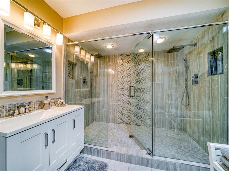 Gorgeous bath with walk in shower and detailed tile work.