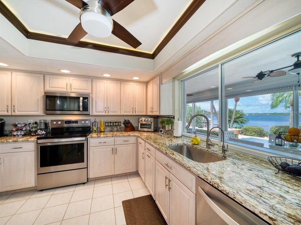 Spacious kitchen with attractive granite counters, new stainless appliances and pass thru to Lanai-did we mention the view?