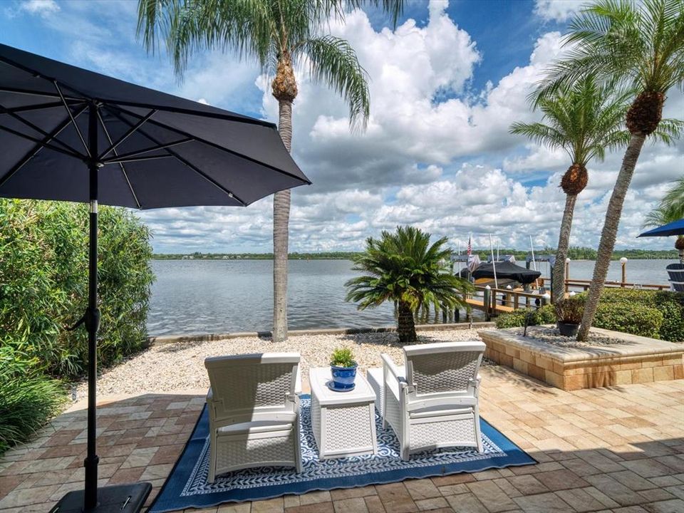 Beautiful views overlooking the wide bay. Brick pavers and  lush landscaping detail this lovely outdoor area.