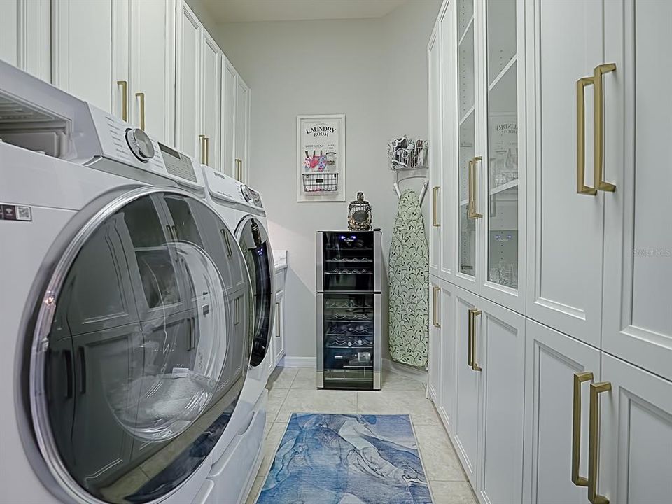 Laundry Room of your dreams. sink, storage, under counter lights, custom California Storage....very classy