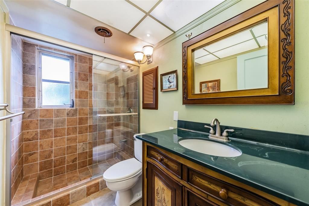 Hall Bath with Tiled Shower and Custom Vanity