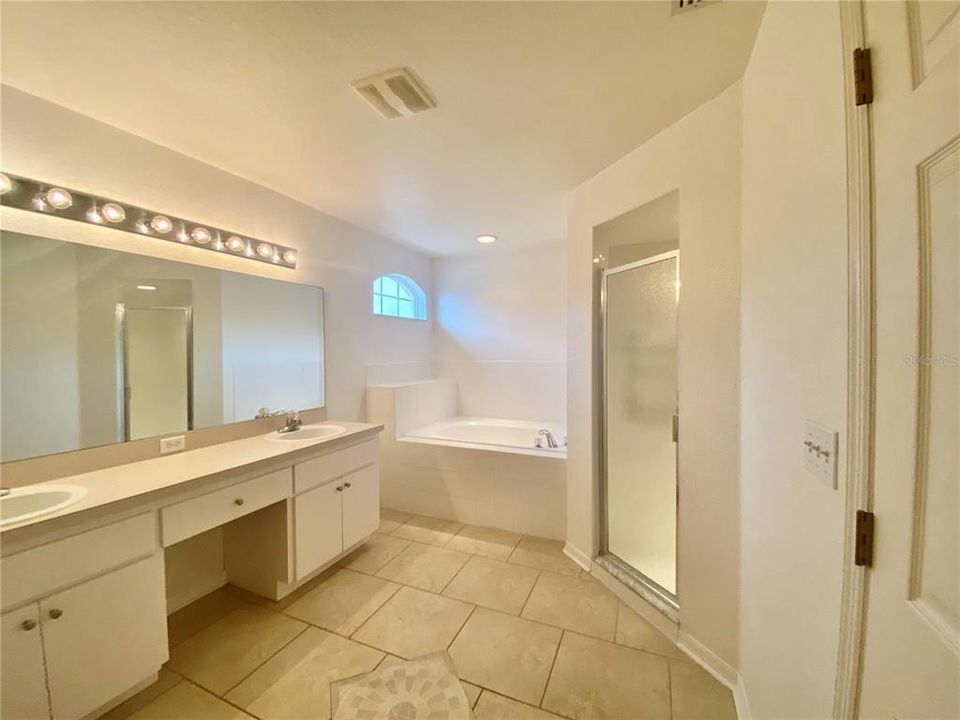 Master Bathroom with dual sinks, shower and garden tub
