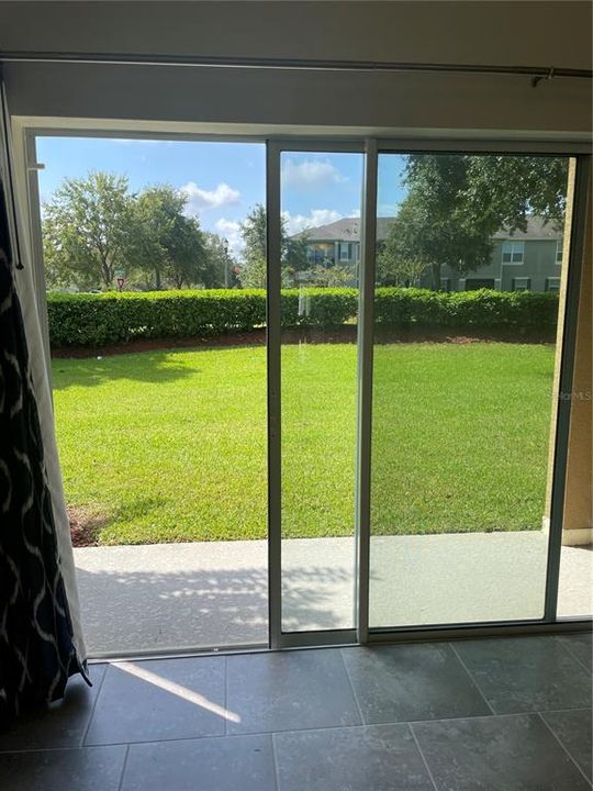 sliding glass door off living room to balcony in backyard