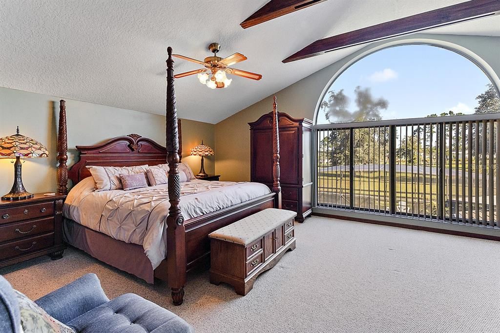 Master Bedroom with Arched Window and Vaulted Ceiling