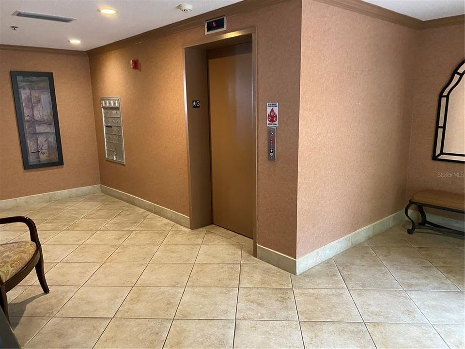 Secure lobby with elevator and mailboxes.