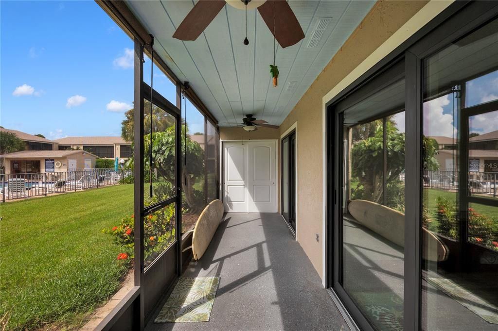 The screened patio features two ceiling fans.