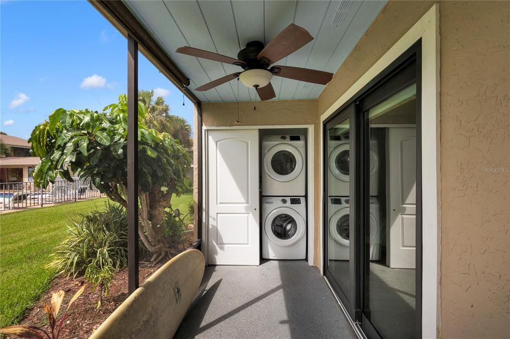 the screened patio features a storage closet with the washer/dryer connections.