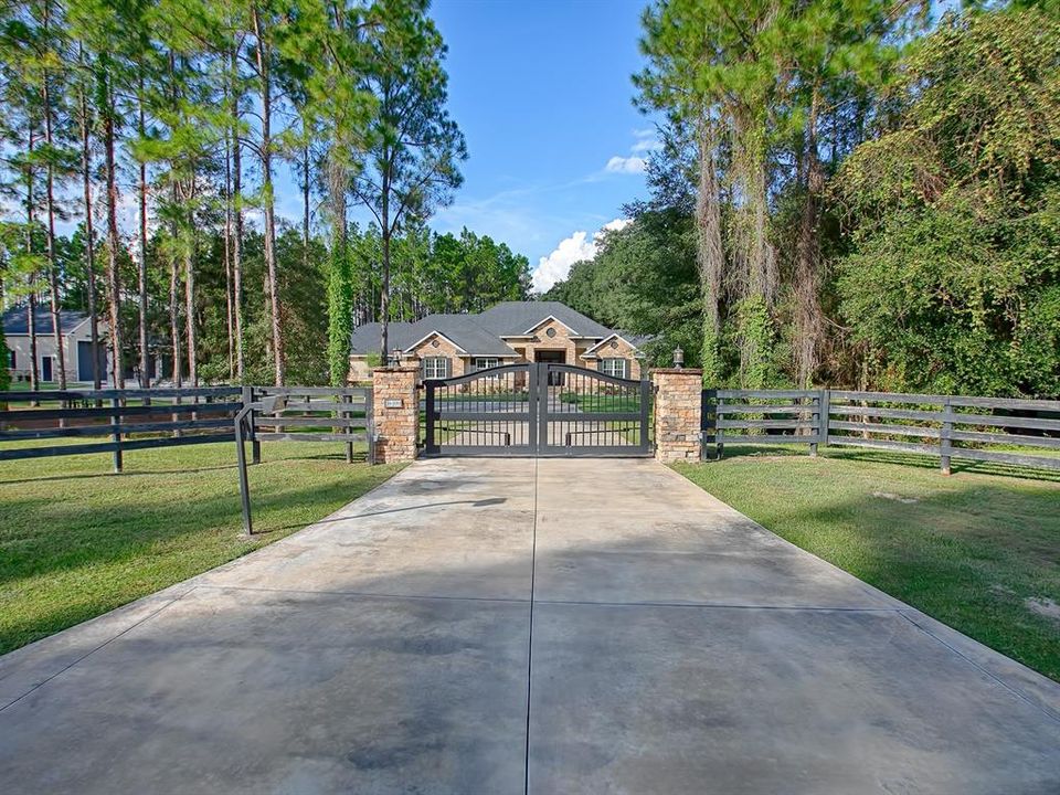 WELCOME TO PARADISE! CUSTOM 7.2 ACRE HOME HOME OFFERS TWO ENTRANCES THAT ARE BOTH GATED