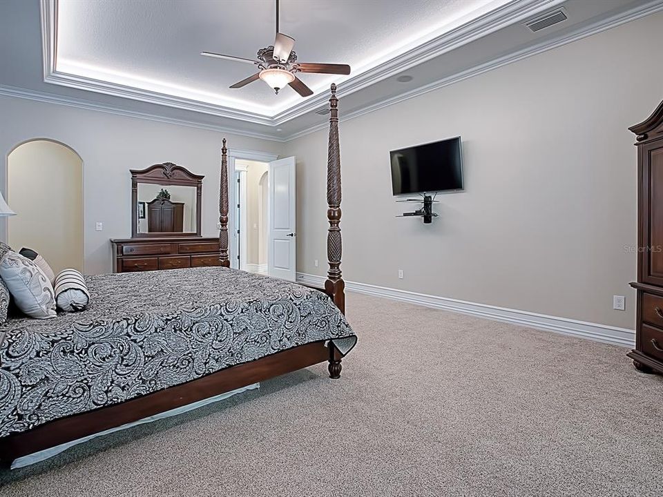 BEAUTIFUL UPLIGHTING AND ARCHED DOORWAYS IN THE MASTER BEDROOM