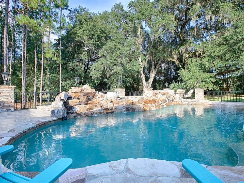 WOW!!! THIS CUSTOM, LAGOON-SHAPED POOL WITH WATERFALL ROCK FORMATIONS IS BEYOND MAGNIFICENT!!! FEATURES TWO FIRE-BOWLS