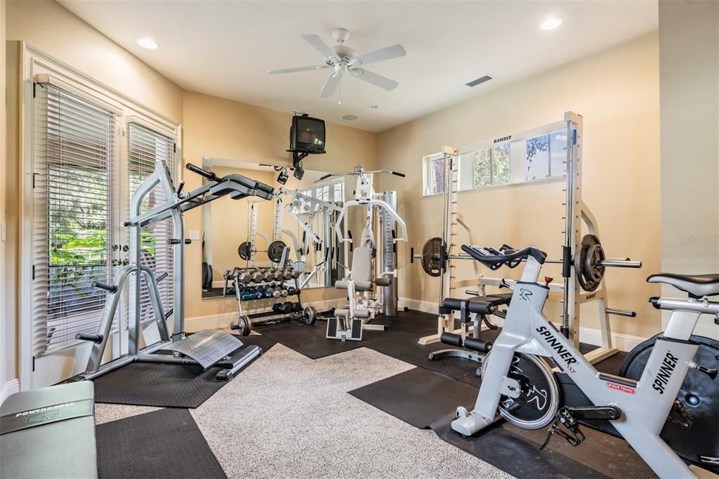 Workout room next to Guest bath with doors that open to pool area