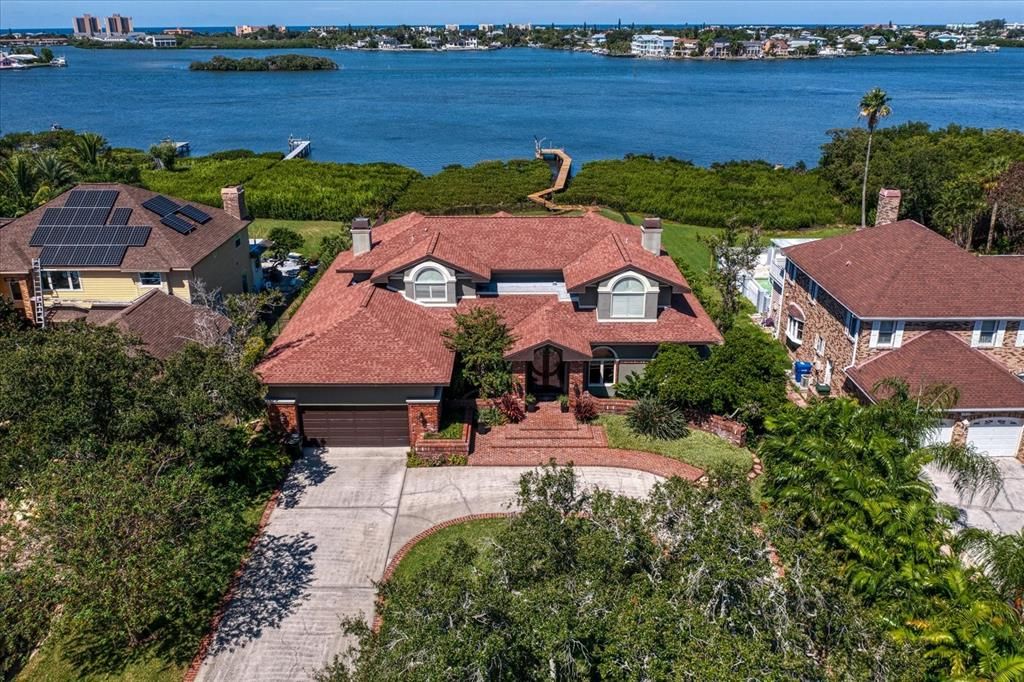 A premier location! With approximately 3/4 acre of lush landscaping, the property extends  300 foot in depth to its natural coastline of 93 foot-quite impressive!