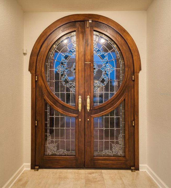 Custom designed with artistic features, the double door entry is a work of art.
