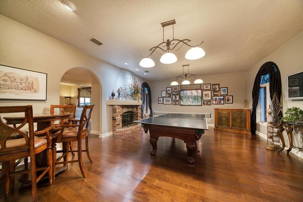 Living room with inviting fireplace- currently used as an entertaining recreation room.