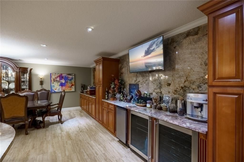 There is a full butlers kitchen in the main dining area with a granite back splash