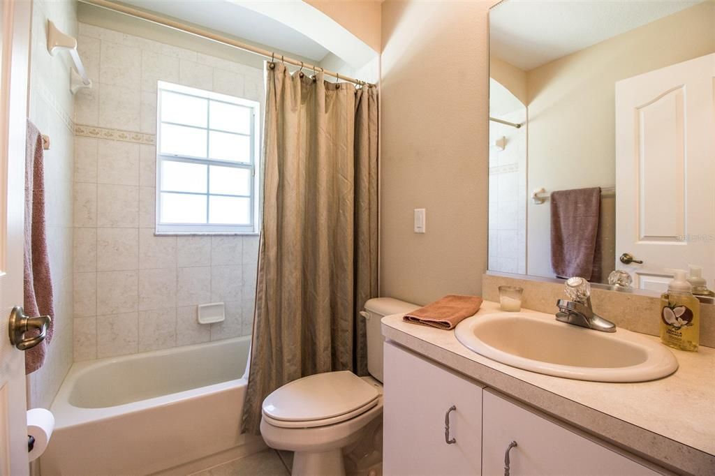Guest bathroom has tub and shower.