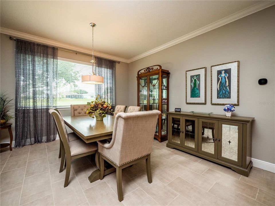 DINING ROOM WITH GOLF COURSE VIEW.