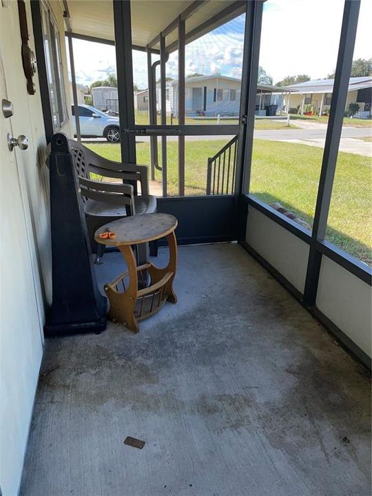 Screened side patio- exterior door leads to living room