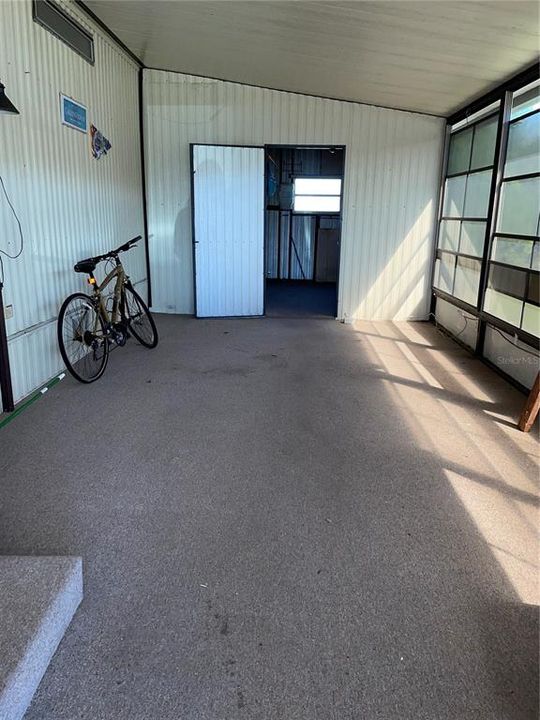 Screened patio off carport with vinyl windows