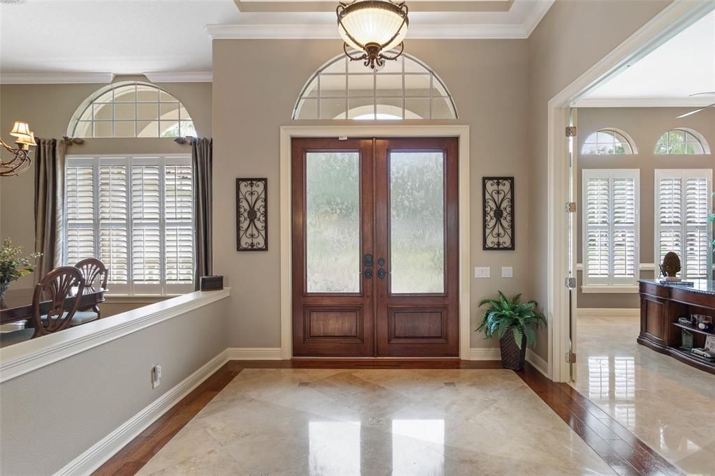 Abundant Light enters this house from the front door panels and the numerous transoms throughout the house. Marble Floors are immaculate!