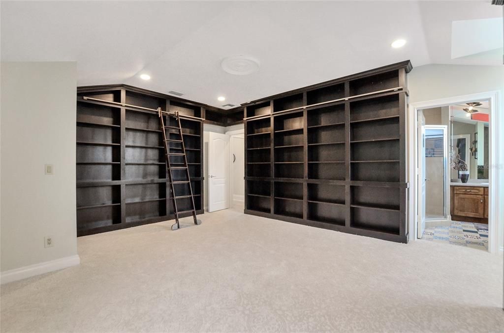 Office with lots of built in bookcases and a secret hidden area