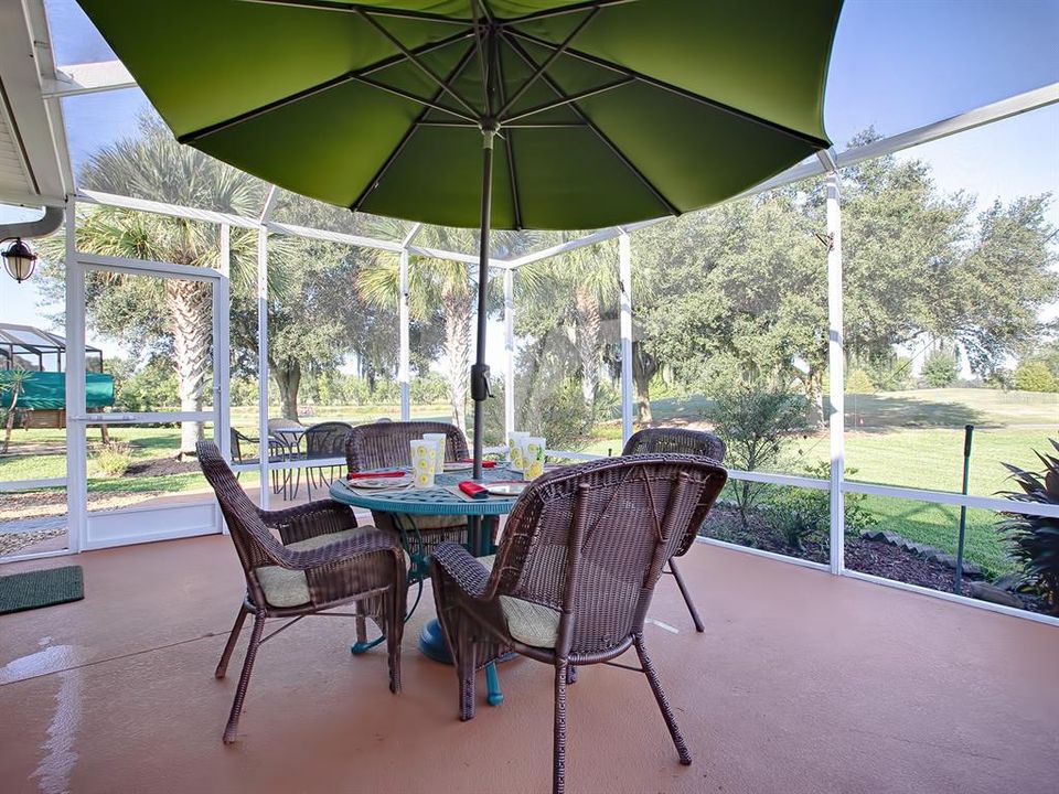 Screened lanai with canvas umbrella for avoiding the sun