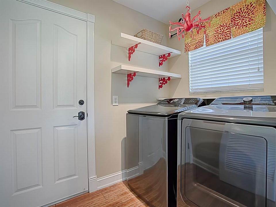 Inside laundry room with washer and dryer that conveys