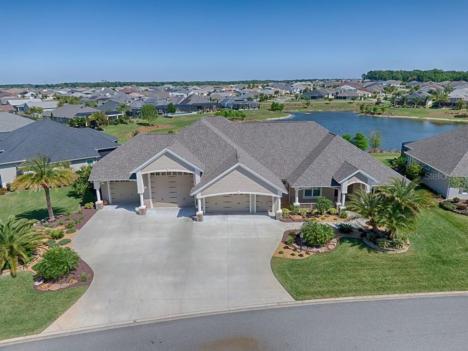 SPECTACULAR 3/3 CUSTOM PREMIER HOME WITH RV GARAGE, 2-CAR GARAGE AND TANDEM GOLF CART GARAGE WITH FABULOUS LAKE VIEWS!