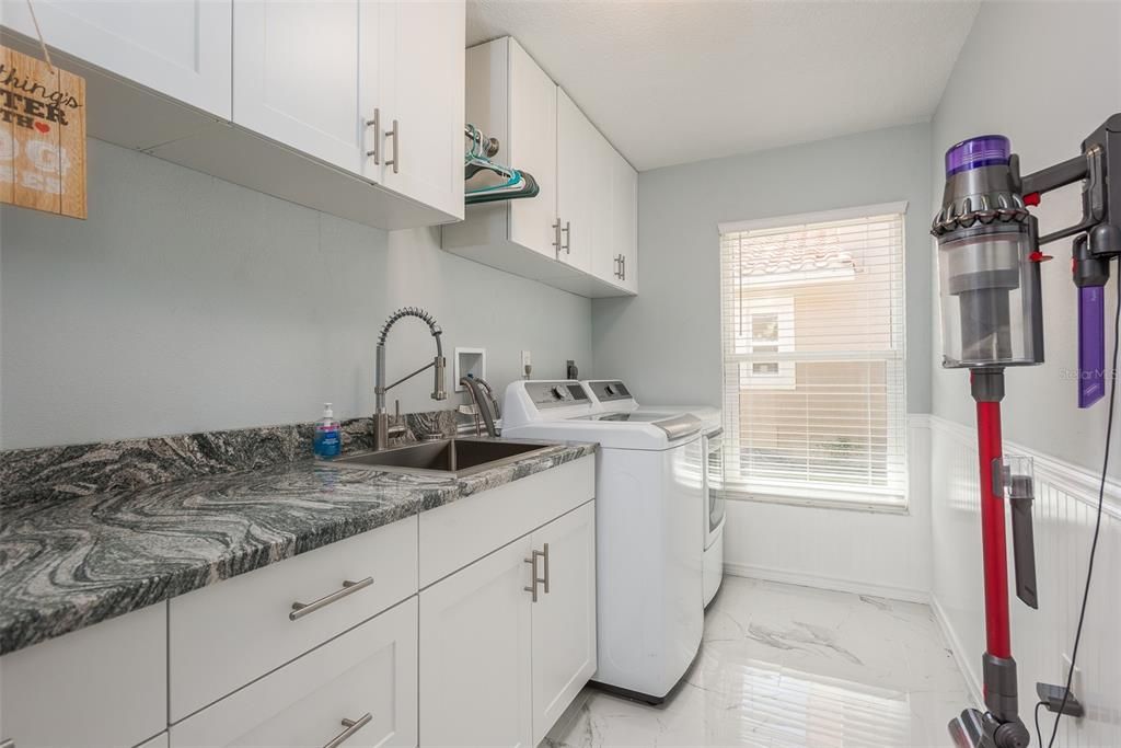 Even the laundry room is gorgeous with the cabinetry, granite and high end fixtures.