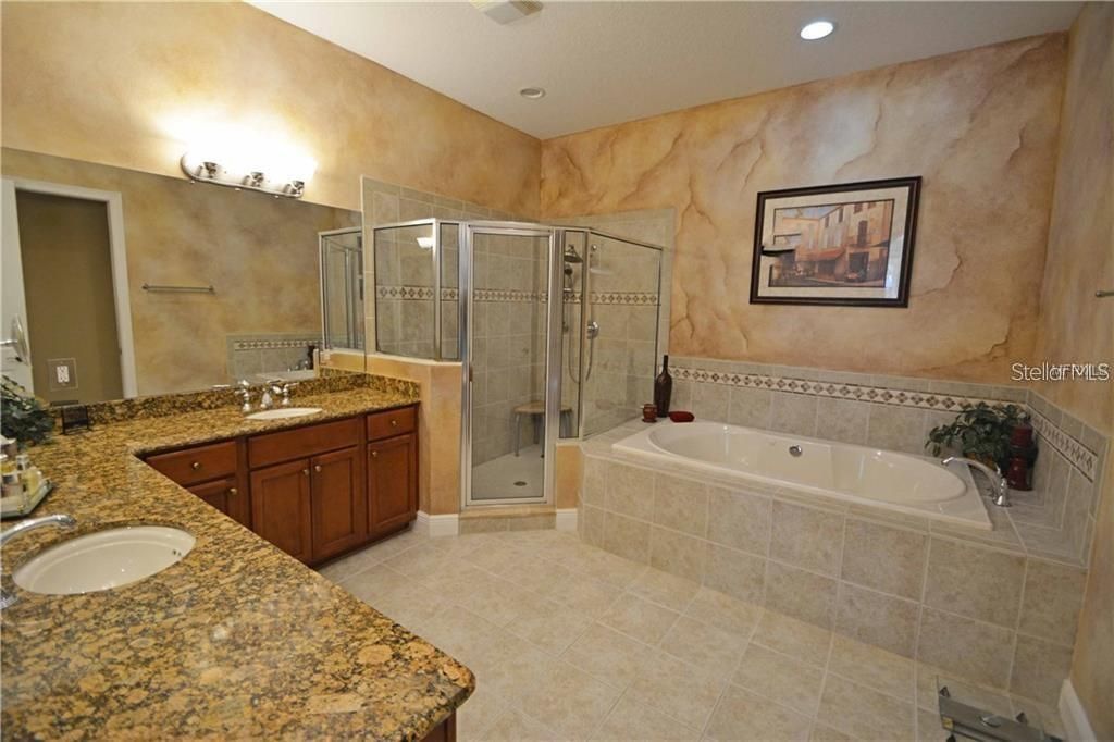 Master bathroom features granite counters & double sinks and deep jetted tub.
