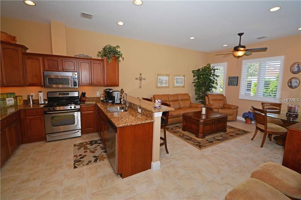 Large kitchen with beautiful granite counters and snack bar.
