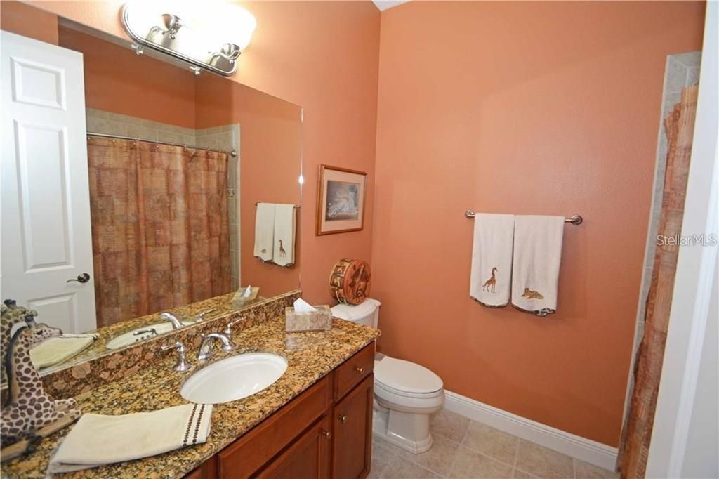 The second bathroom features granite counters, bath tub & shower.