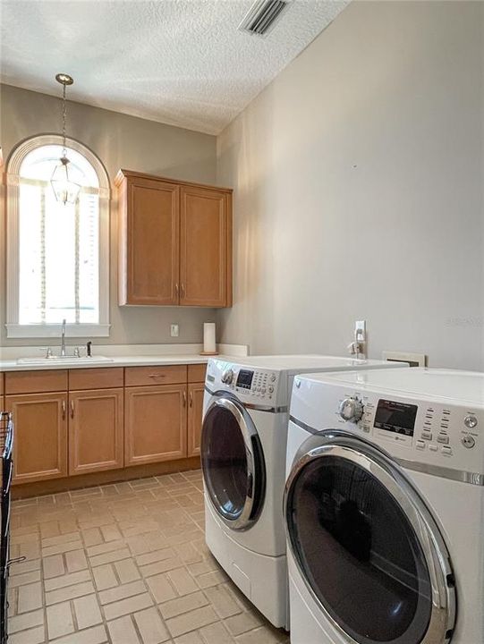 Laundry room with sink and plenty of storage