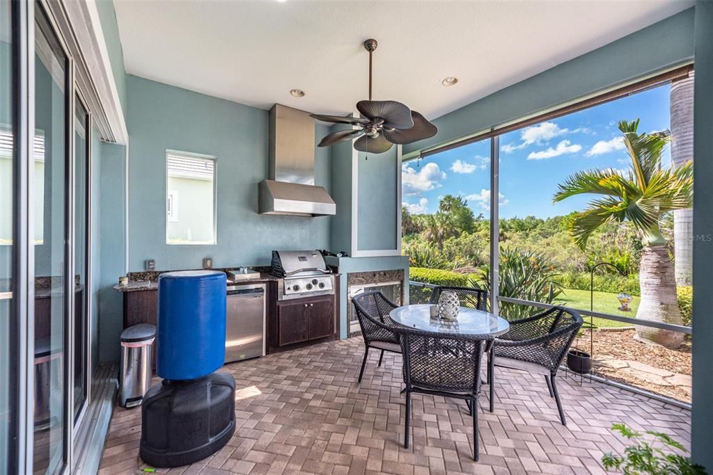 Complete outdoor kitchen with large cover seating area.  Hang out in the Sade under the fan, or Fire up the gas fireplace and take the chill off durning our incredible Florida winters.  Internals of the grill were recently replace and companion gas burner was added.