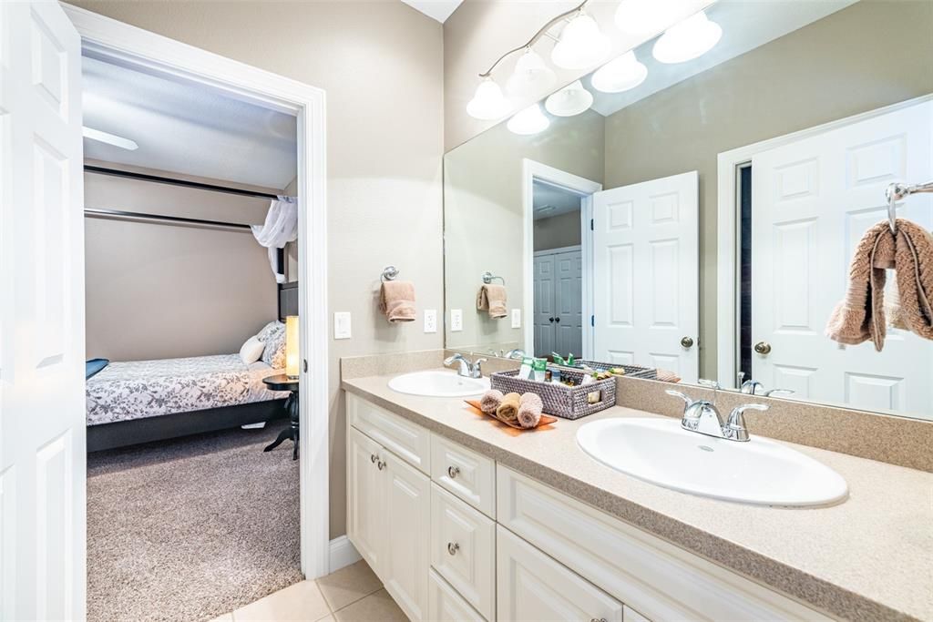 The jack and Jill bathroom located between bedrooms 3 and 4 has dual sinks, and separate tub with shower.