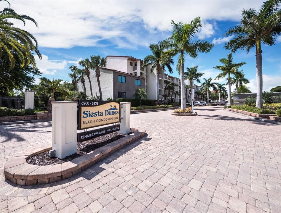 Welcome to Siesta Dunes on Siesta Key Beach. This first floor end-unit is conveniently located in the first building to the left once you pass through the gated entrance.