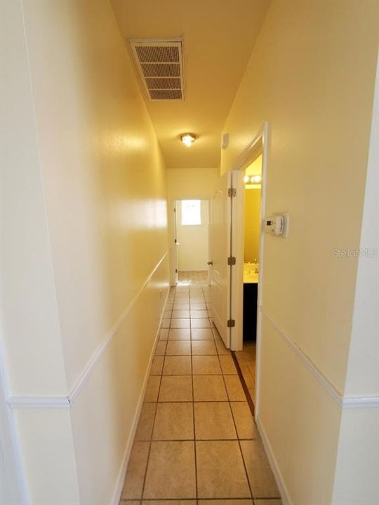 hallway past 1/2 bathroom to laundry