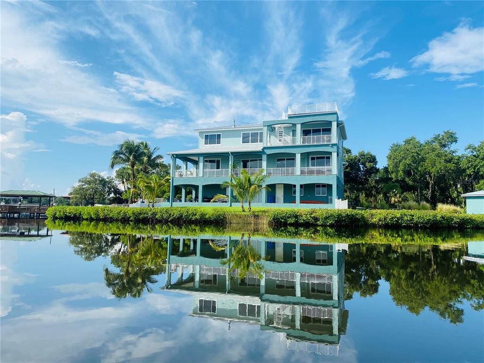 Mangroves appear as a manicured hedge around this stately home from the calming waters of the Manatee River.