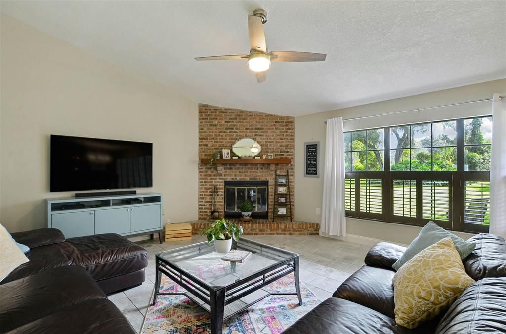 Enjoy the wood burning, brick fireplace as well as large windows with private views of the backyard.