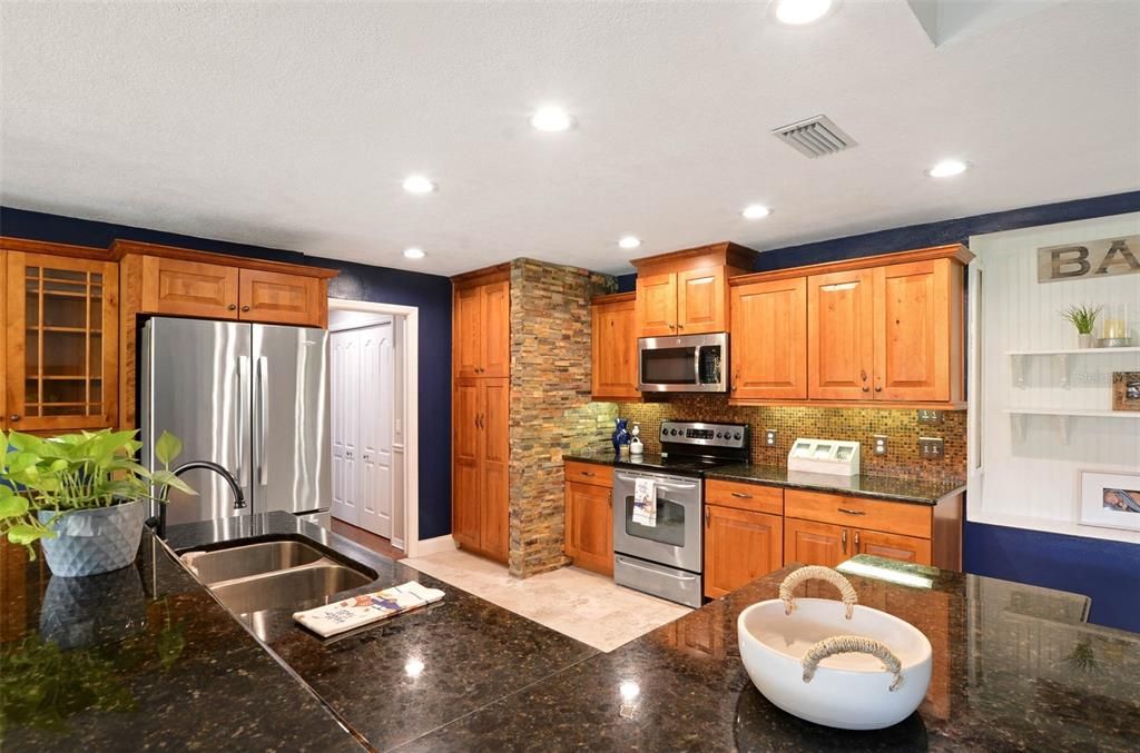 Enjoy your kitchen with backsplash and stone accent wall.  Granite countertops.