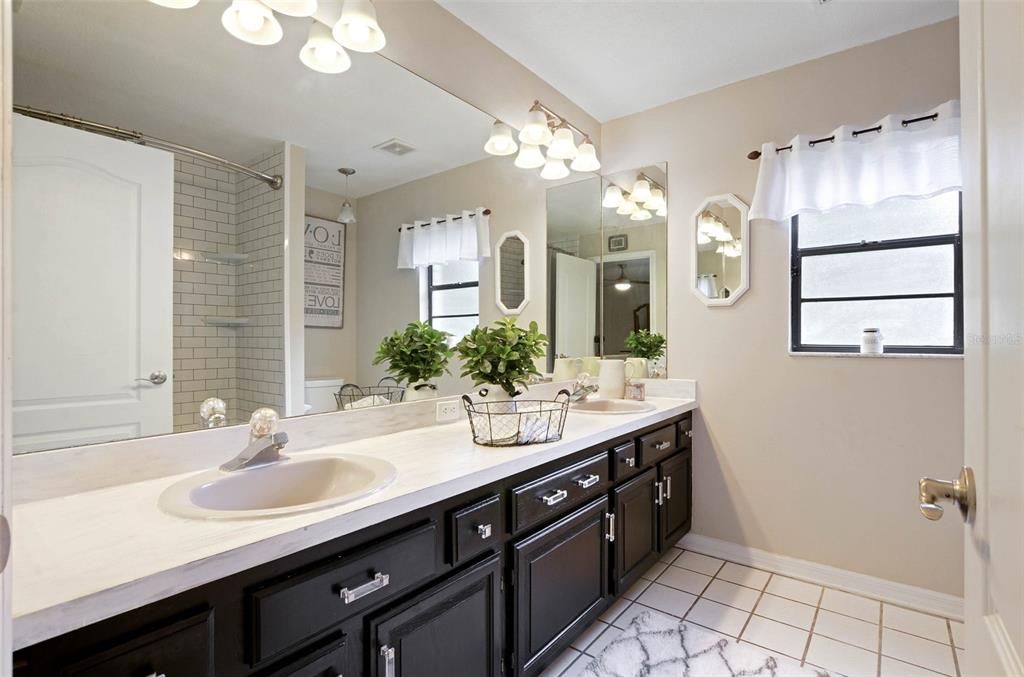 Master bath with jack & jill sinks, tile flooring, bright lighting- newly renovated!