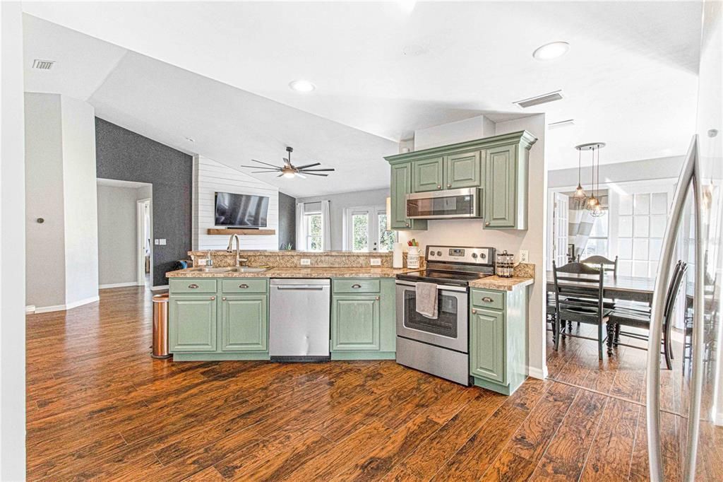 Kitchen with refinished cabinets / leading into dining room