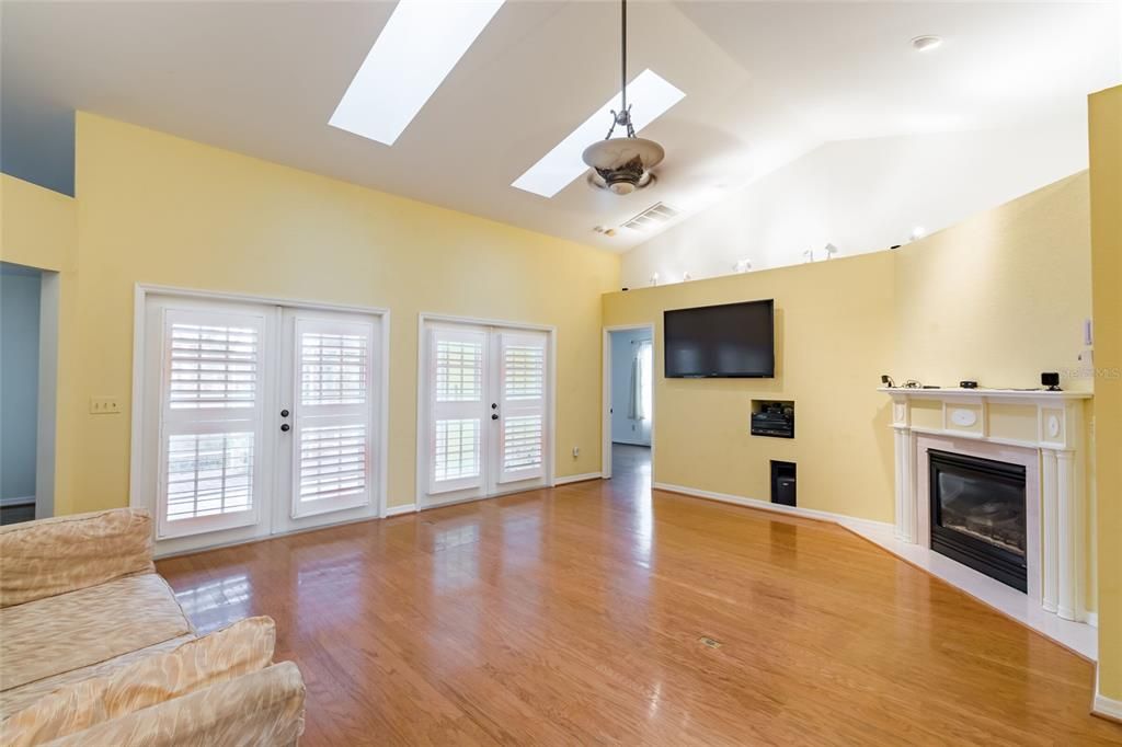 Great room viewed from laundry room & front door entry foyer