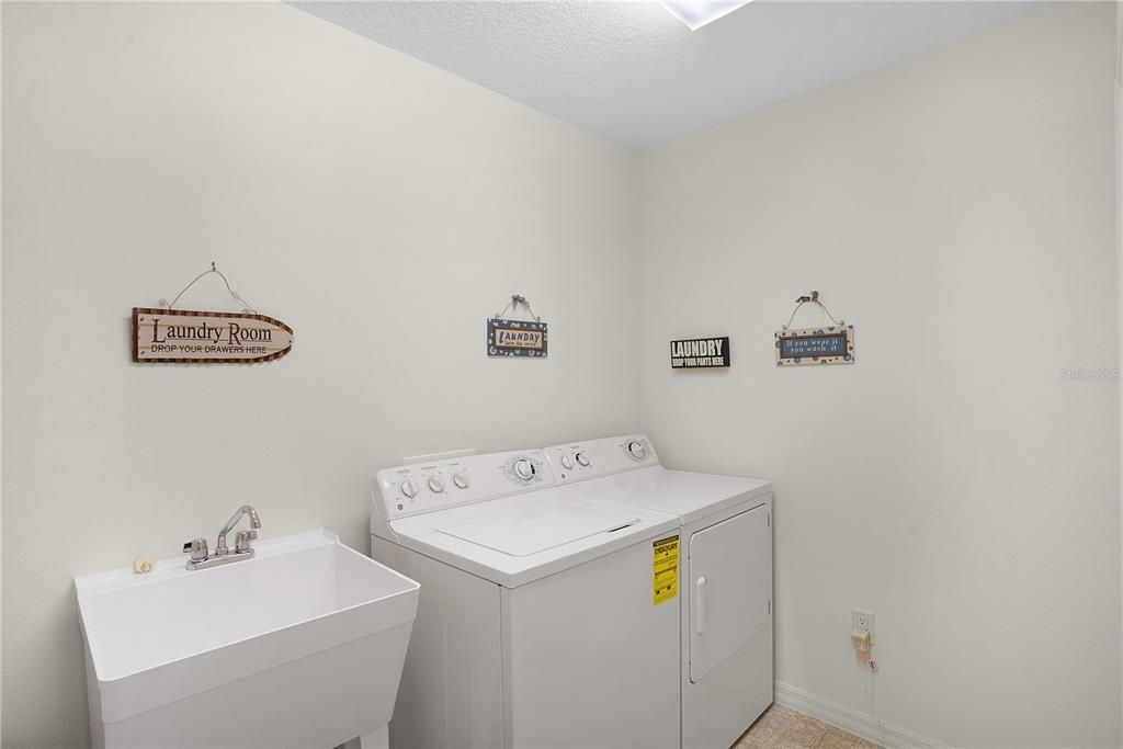 LAUNDRY ROOM WITH MOP SINK AND BARELY USED WASHER/DRYER