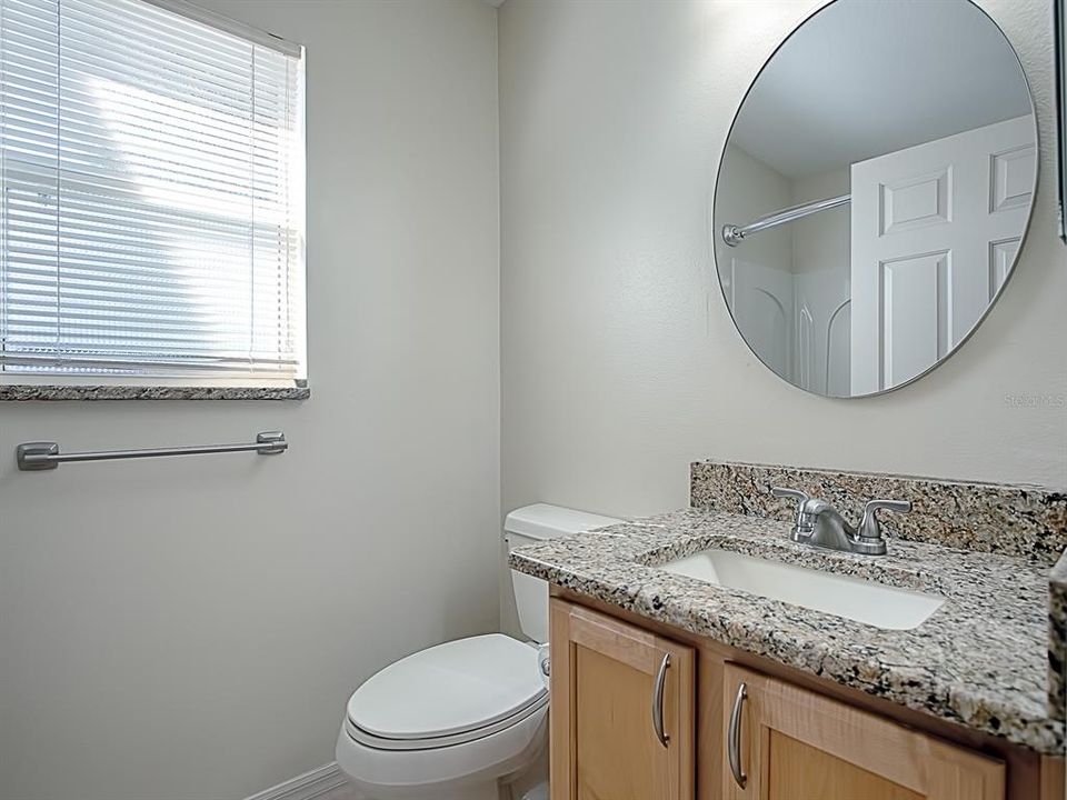 GUEST BATH FRESHLY PATINED WITH UPDATED LIGHT FIXTURE AND MIRROR! GRANITE COUNTER TOP!
