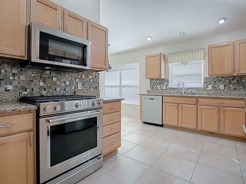 ALL NEW KITCHEN-AID STAINLESS APPLIANCES WITH BOTTOM FREEZER REFRIGERATOR AND GAS STOVE, MOSAIC TILE BACKSPLASH, GRANITE COUNTER TOPS, PANTRY WITH PULL-OUT DRAWERS!